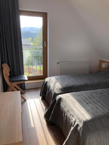 a bedroom with two beds and a large window at CASA SMIDA JAZZ in Smida