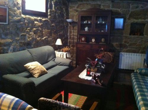 a living room with a couch and a table at Casa das Augas Santas in Aguas Santas