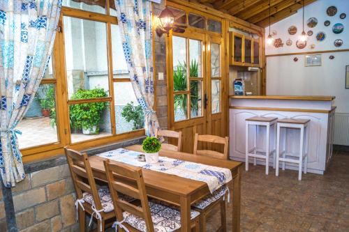 a kitchen and dining room with a table and chairs at Chrystal Guest House in Obzor