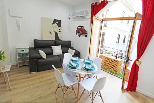 a living room with a table and chairs and a couch at Apartamento muy céntrico 5 minutos playa (2º) in Alicante