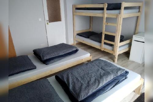 a room with two bunk beds and a ladder at Kwatera u Somsiada -Apartament in Muszyna
