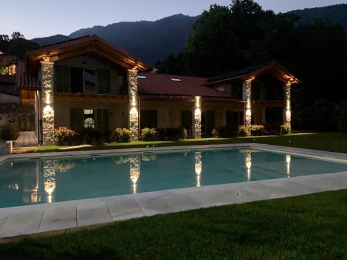 a house with a swimming pool in the yard at House & Pool in Mergozzo