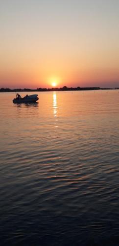 a boat on a body of water at sunset at Horio House in Límni