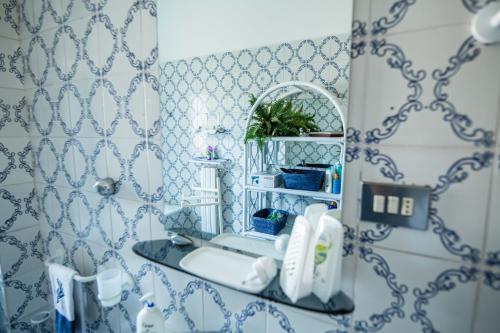 a bathroom with a sink and a mirror at Virginia's Guest House in Sorrento