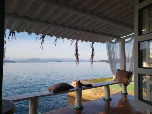 a view from the porch of a house overlooking the water at Cabana do Mar in Angra dos Reis