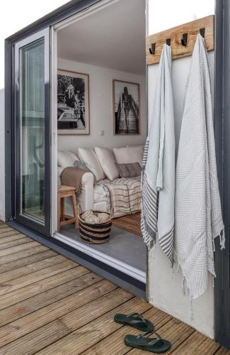 a living room with a couch and a window at Bem Lembrados Apartment in Cascais