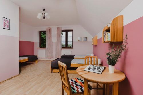 a living room with a bed and a table at Szumilas miejsce spotkań in Bydgoszcz