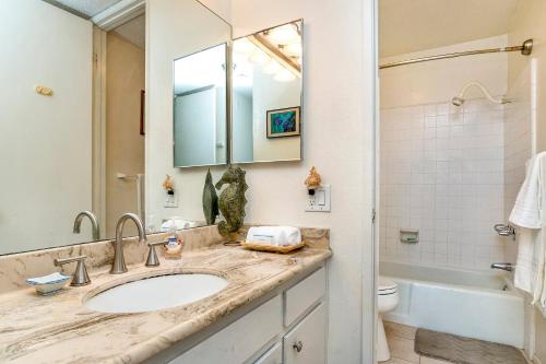 a bathroom with a sink and a toilet and a mirror at Condo in Beachfront Resort B-212 in Oceanside
