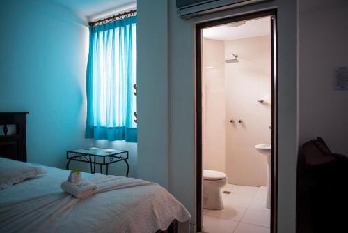 a bedroom with a teddy bear sitting on a bed at Buen Retiro Apart Hotel in Santa Cruz de la Sierra