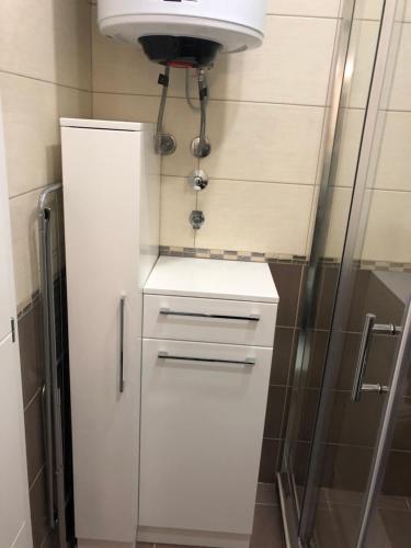 巴尼亚科维利亚查Apartman Jezdić 2的白色橱柜,浴室内设有水槽