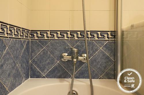 a shower with a faucet in a bathroom at Cascais Estoril Apartment 400 m from Beach in Estoril