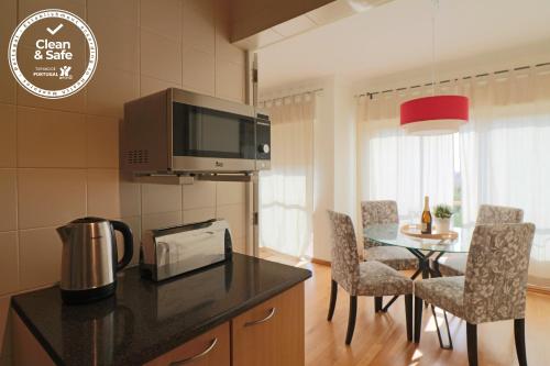 a kitchen and dining room with a table with chairs at Cascais Estoril Apartment 400 m from Beach in Estoril