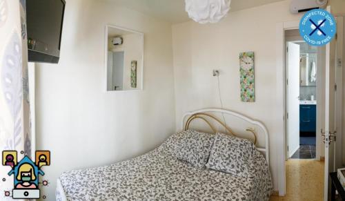 ガンディアにあるHospedaje Gandia Ciudadのベッドルーム1室(ベッド1台、壁掛け時計付)