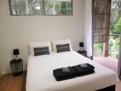 una camera da letto con un letto bianco con due asciugamani di Stay @ LP Montville a Montville