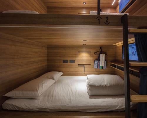 a bedroom with a bed in a bunk bedded room at Hotel Leisure 台南行旅-巷弄潮旅 in Tainan