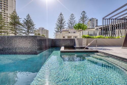 a swimming pool in the middle of a building at Vue Broadbeach in Gold Coast