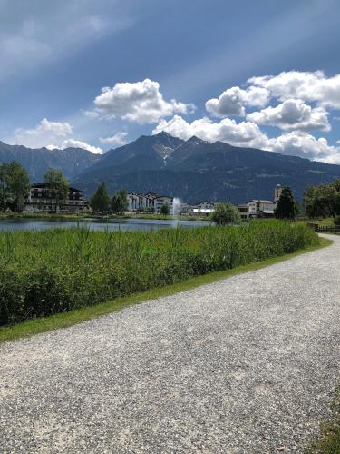 a road with a view of a river and mountains at Rancho Laaxdeluxe in Laax