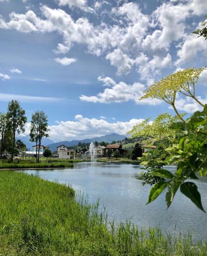 a view of a river with buildings in the background at Rancho Laaxdeluxe in Laax