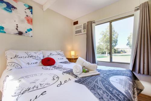 a bedroom with a bed and a window at Tasman Holiday Parks - Serpentine Falls in Serpentine