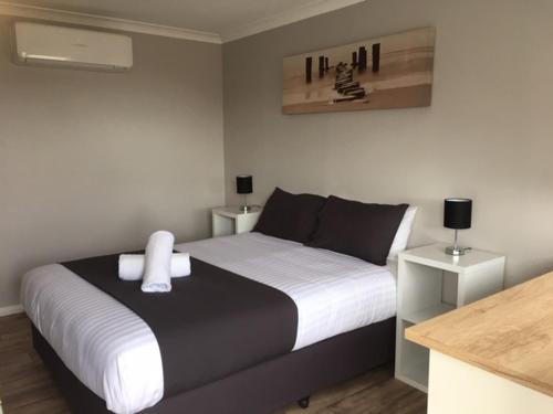 a bedroom with a black and white bed and a counter at Border Village Roadhouse in Border Village