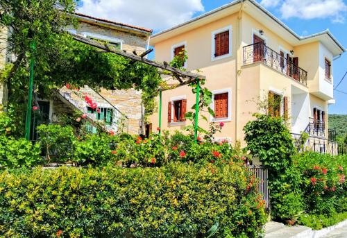 a house with flowers in front of it at Pelion Seaside Luxury House in Afissos
