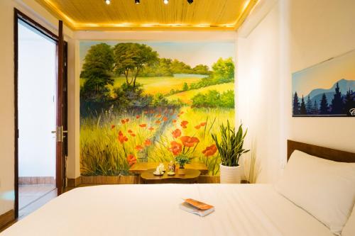 a bedroom with a painting on the wall at The Autumn Homestel in Hanoi