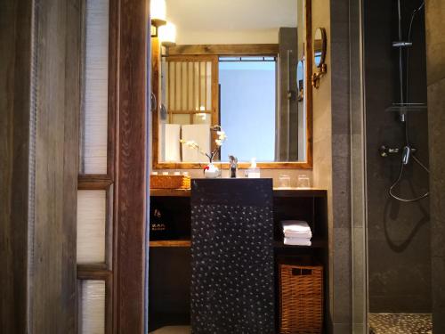 a bathroom with a sink and a mirror at 武当山太和紫隐酒店 in Wudangshan
