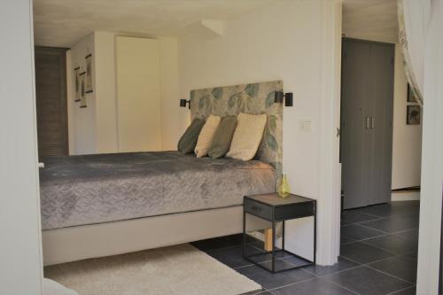 a bedroom with a bed with a large mirror at BzonderB Callantsoog in Callantsoog
