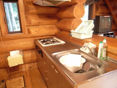 a kitchen with a sink and a stove at Cottage All Resort Service / Vacation STAY 8420 in Inawashiro