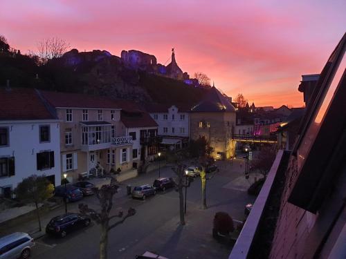 a city with cars parked on a street at sunset at Bed and Breakfast De Heren van Valkenburg in Valkenburg