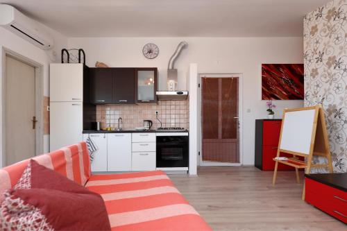 a living room with a couch and a kitchen at Apartment Zanov in Preko