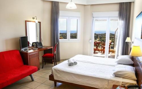 Schlafzimmer mit einem Bett, einem Schreibtisch und einem roten Stuhl in der Unterkunft Alea Resort in Parga