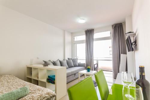 a living room with a couch and a window at Apartment Bonamar in Las Palmas de Gran Canaria