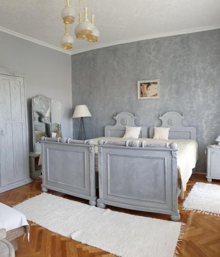 a bedroom with two twin beds in a room at Domboldal Vendégház in Noszvaj