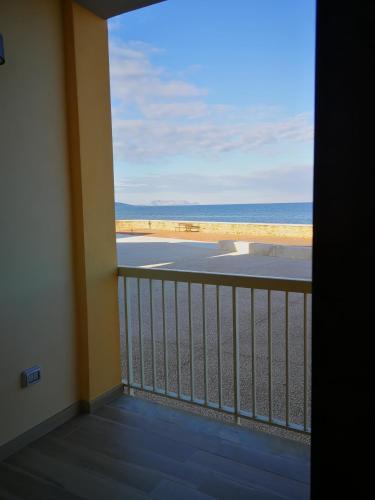 a balcony with a view of the beach at Santa Lucia fronte mare in Santa Lucia