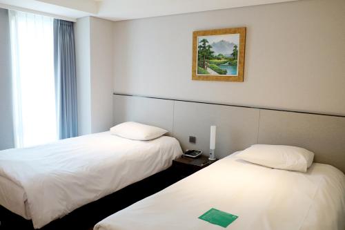 Tempat tidur dalam kamar di Hotel Thomas Myeongdong