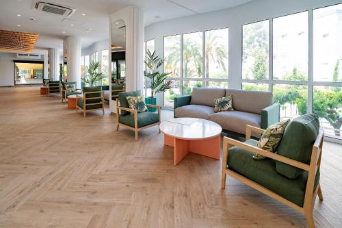 a living room filled with furniture and a large window at Medplaya Hotel Calypso in Salou