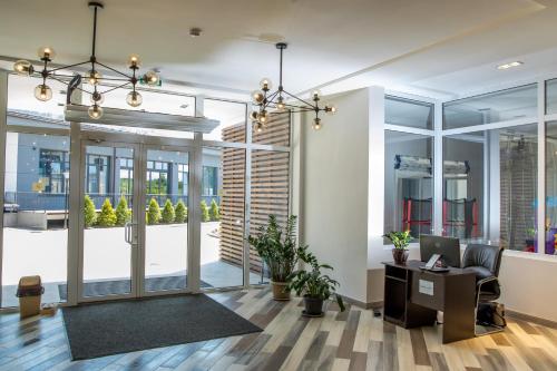 an office with glass doors and a desk with a computer at Гостиничный комплекс Be Fine in Besqaynar
