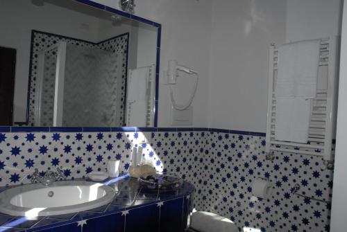 a bathroom with a sink and a mirror at La Meridiana Relais in Formello