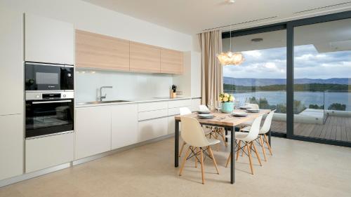 a kitchen with a table and chairs with a view at Villa Eola Hvar in Jelsa
