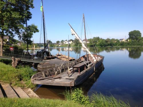 a boat is docked at a dock on the water at Pavillon en Touraine in Savonnières