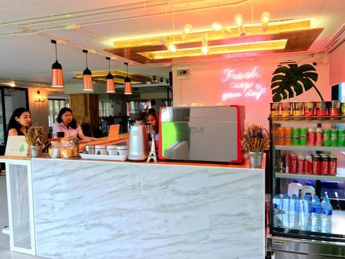 a counter in a restaurant with people standing behind it at R1 Nimman Hotel Chiangmai in Chiang Mai