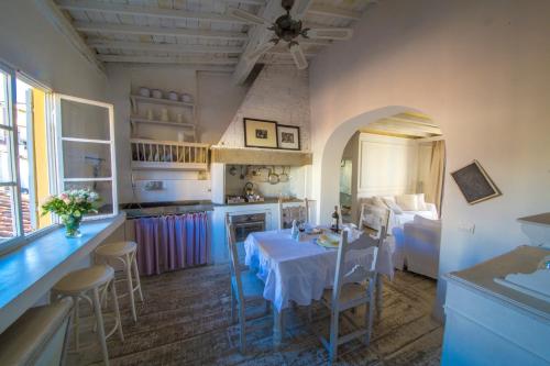 a kitchen and dining room with a table and chairs at White Home in Florence