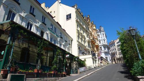 an empty street in a city with buildings at Chebsky dvur - Egerlander Hof in Karlovy Vary