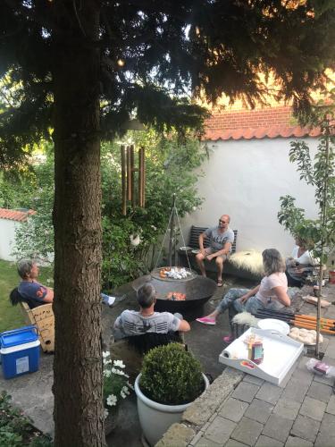 a group of people sitting around in a yard at Tåning Gl. Mejeri in Skanderborg