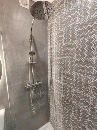 a bathroom with a shower with a glass door at Santa Cruz Ocean Apartment - I in Santa Cruz