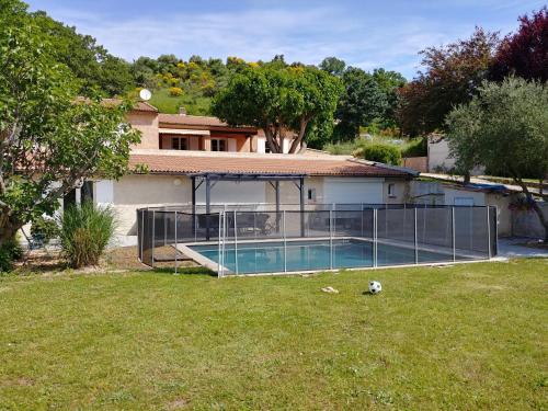 a house with a swimming pool in a yard at Gite Kalinka in Valensole