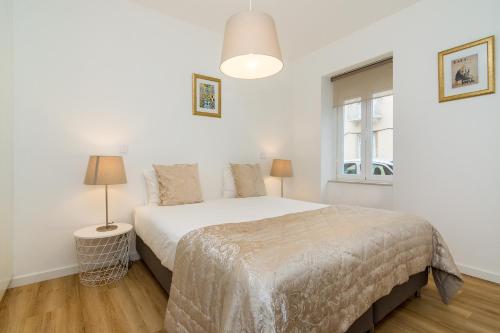 リスボンにあるWHome | Graça Premium Apartment #27の白いベッドルーム(ベッド1台、ランプ2つ付)