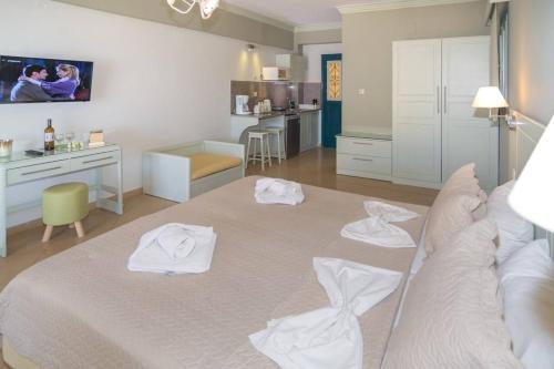 a hotel room with a bed and a table at ELENA APARTMENTS in Masouri