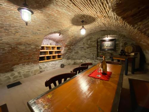 a dining room with a wooden table and chairs at Taschler Haus in Sighişoara